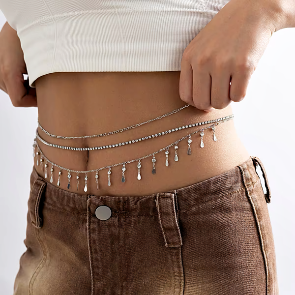 A 3-layer body chain in silver-plating. The top layer is a delicate silver chain, the middle layer is a row of diamante crystals and the bottom layer is a dangling row of cubic zirconia stones with oval silver charms.